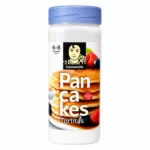 Préparation pour pancakes sans gluten Carmencita 150 g dans un emballage cylindrique avec couvercle bleu sur fond blanc.